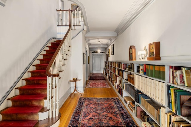 interior space with crown molding and light wood-type flooring