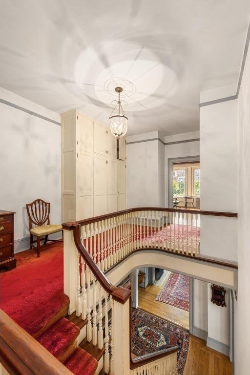 staircase featuring an inviting chandelier