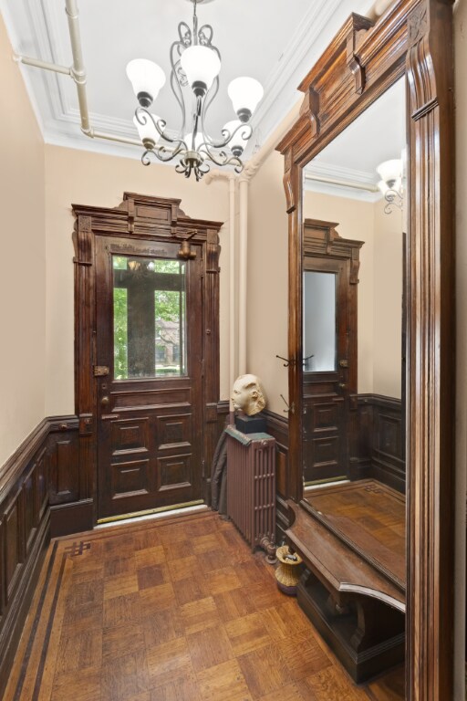 bedroom with dark wood-type flooring, radiator heating unit, and floor to ceiling windows