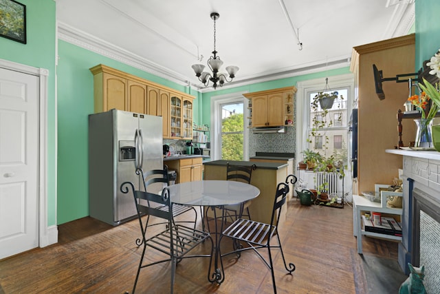 doorway to outside with a notable chandelier, crown molding, and dark parquet flooring