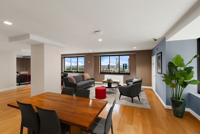 dining area with light wood-style floors, recessed lighting, and baseboards