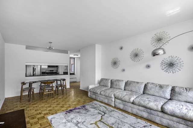living area featuring a baseboard radiator and baseboards