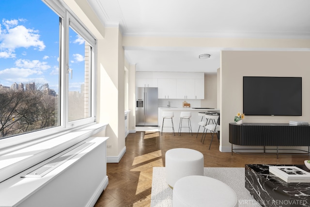 living room with dark parquet flooring and ornamental molding