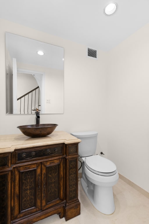 bathroom featuring vanity and toilet