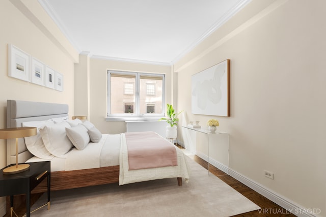 bedroom with crown molding and hardwood / wood-style flooring