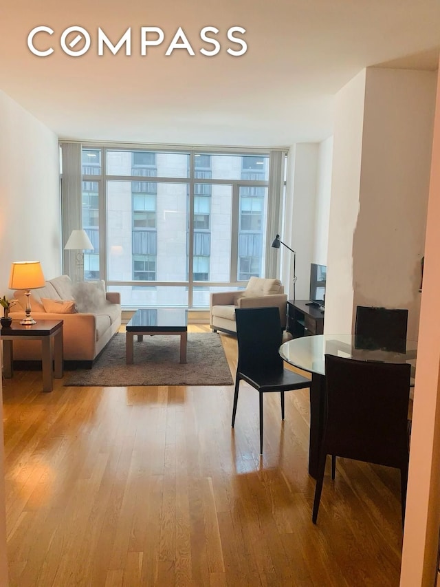 living area with wood finished floors and expansive windows