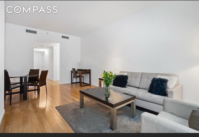 living room with visible vents and wood finished floors