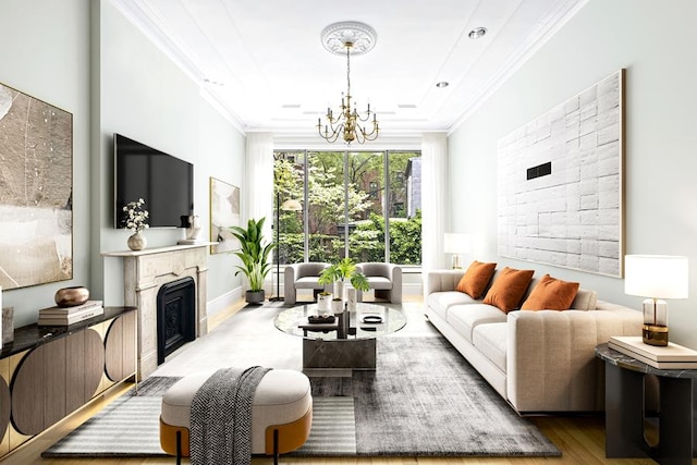 living area with a chandelier, ornamental molding, wood finished floors, and a fireplace
