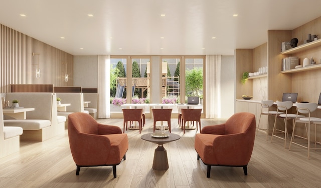 interior space featuring light hardwood / wood-style flooring and wood walls