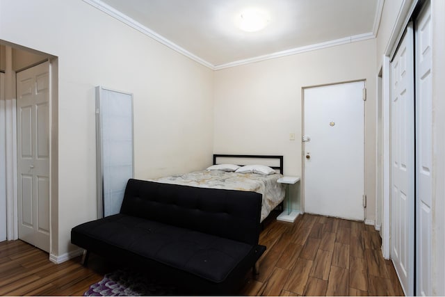 bedroom featuring wood finished floors and ornamental molding