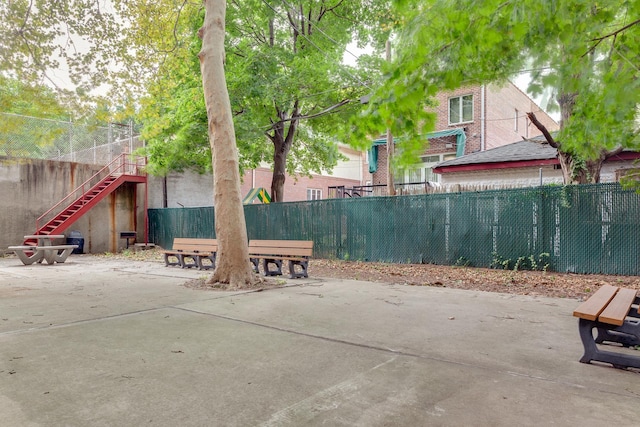 view of patio with stairs and fence