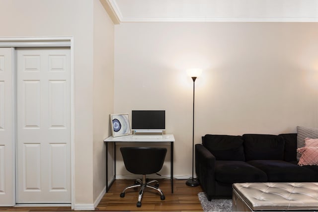 office space with ornamental molding, baseboards, and wood finished floors