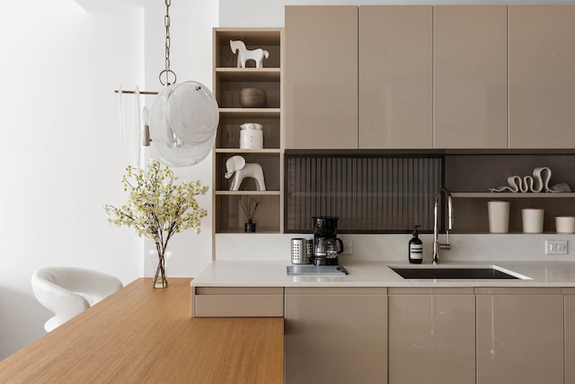 kitchen with open shelves, modern cabinets, light countertops, and a sink