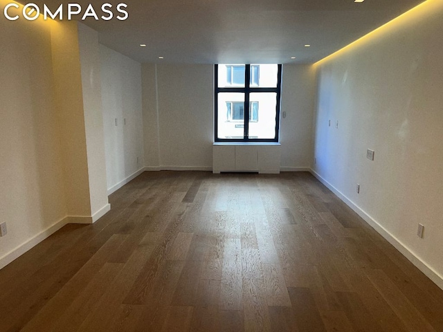 empty room with dark wood-type flooring