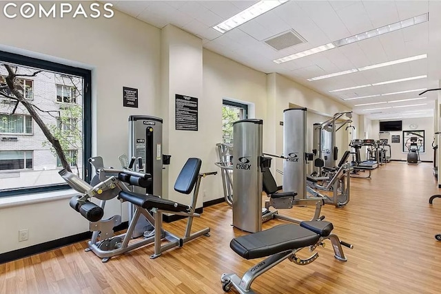 workout area with light hardwood / wood-style flooring