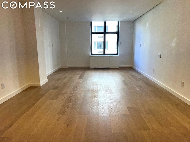 empty room featuring hardwood / wood-style flooring