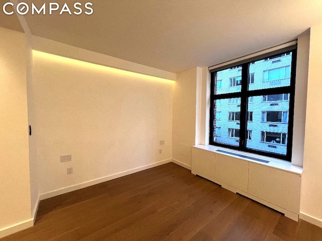 unfurnished room featuring hardwood / wood-style flooring