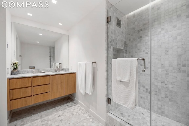 bathroom with vanity and a shower with shower door