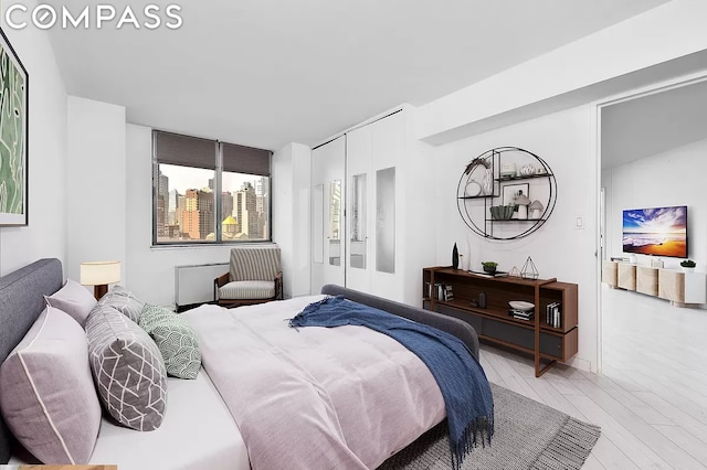 bedroom featuring light hardwood / wood-style flooring and a closet