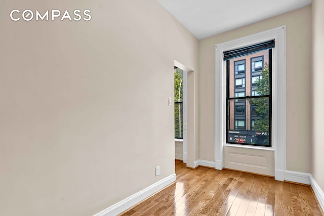 unfurnished room featuring light wood-style floors and baseboards