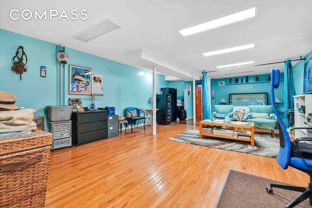 interior space featuring attic access and wood finished floors