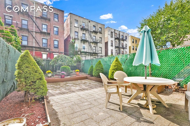 exterior space featuring outdoor dining area and a fenced backyard