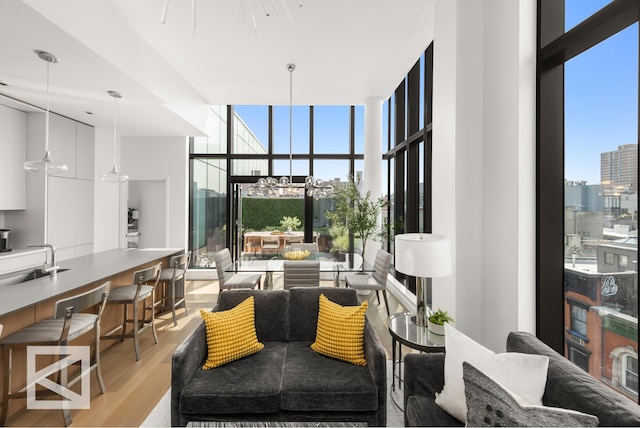 living room with light wood-style flooring and floor to ceiling windows