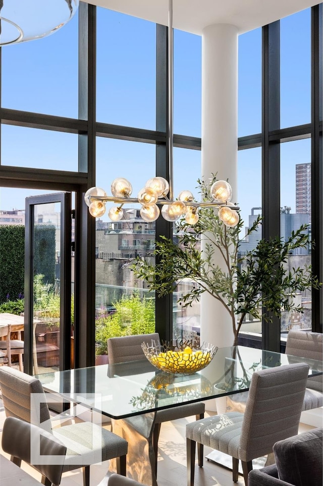 dining space featuring a wall of windows and a high ceiling