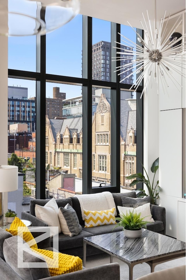 living room featuring a notable chandelier, floor to ceiling windows, and a city view