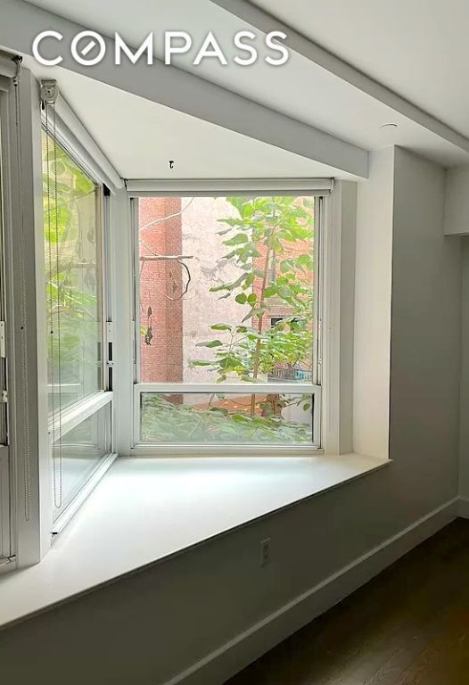 interior space with dark hardwood / wood-style flooring and plenty of natural light