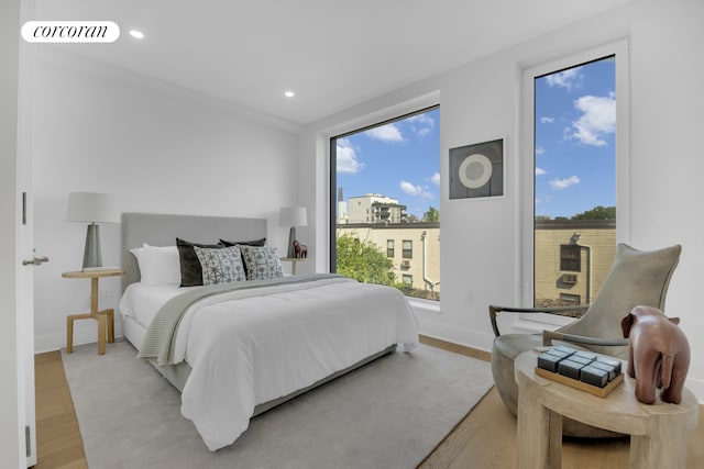 bedroom with recessed lighting, visible vents, multiple windows, and wood finished floors