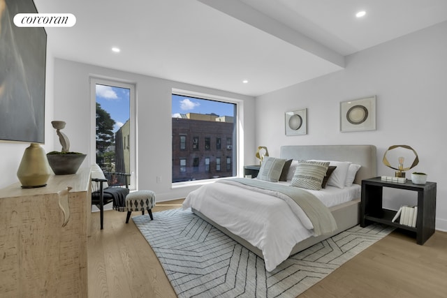 bedroom with multiple windows, recessed lighting, and light wood-type flooring