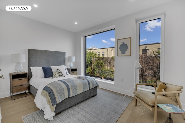 bedroom with recessed lighting, visible vents, baseboards, and wood finished floors