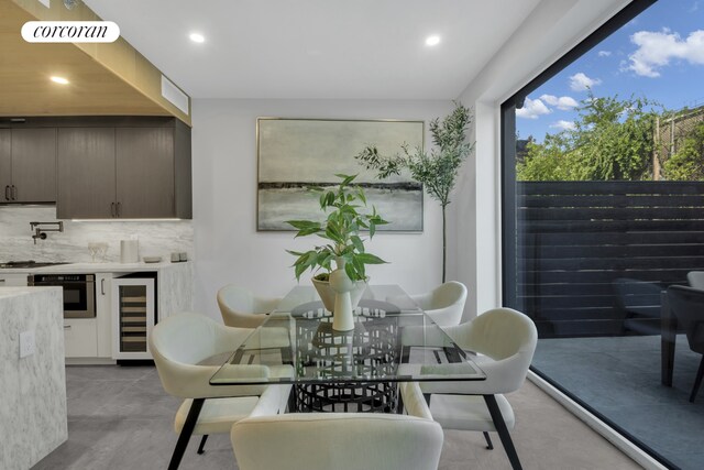 dining area featuring recessed lighting, visible vents, wine cooler, and finished concrete flooring