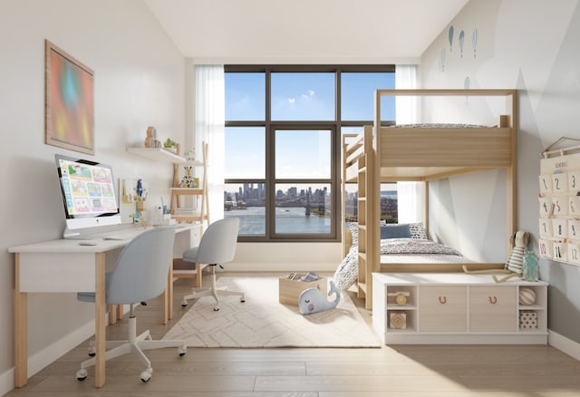 office featuring light hardwood / wood-style flooring, vaulted ceiling, and a water view