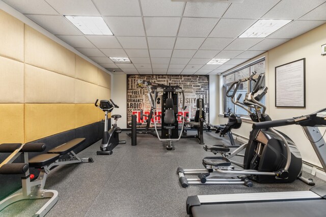 workout area featuring a drop ceiling