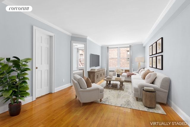 living room featuring hardwood / wood-style flooring and crown molding