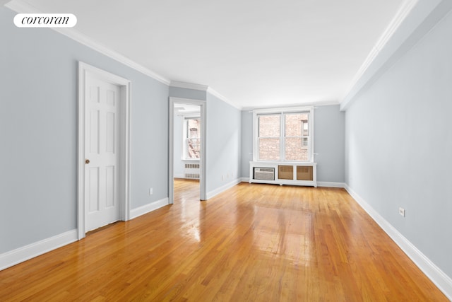 unfurnished living room featuring crown molding, radiator heating unit, and light hardwood / wood-style floors