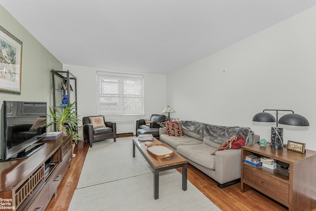 living area featuring radiator heating unit and light wood-type flooring