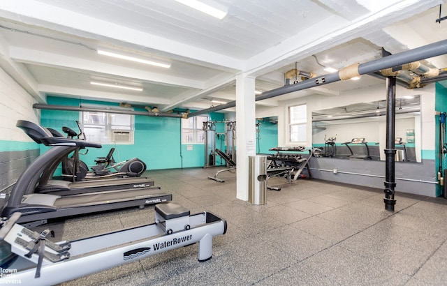 exercise room with cooling unit and concrete block wall