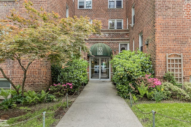 view of exterior entry with french doors and brick siding