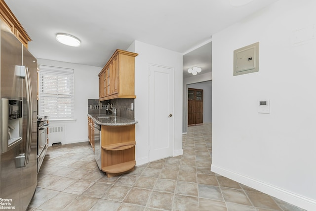 kitchen with stone countertops, backsplash, stainless steel appliances, open shelves, and a sink