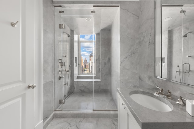 bathroom featuring vanity, marble finish floor, and a marble finish shower