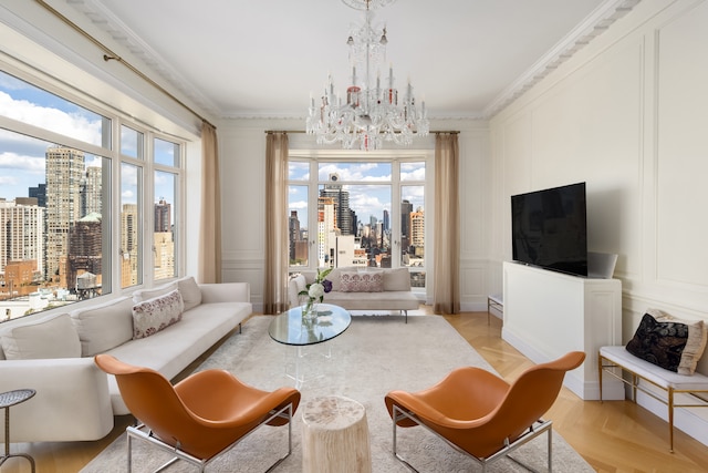 living area with a notable chandelier, a decorative wall, and crown molding