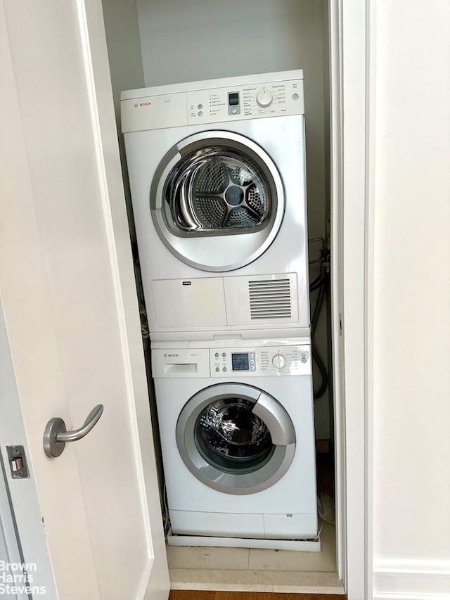 laundry area featuring laundry area and stacked washer / drying machine