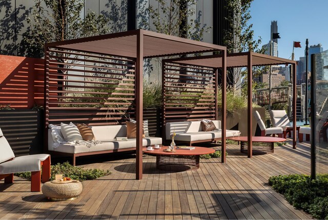 wooden terrace featuring outdoor lounge area and a city view