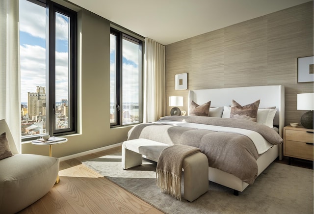 bedroom featuring wood finished floors and baseboards