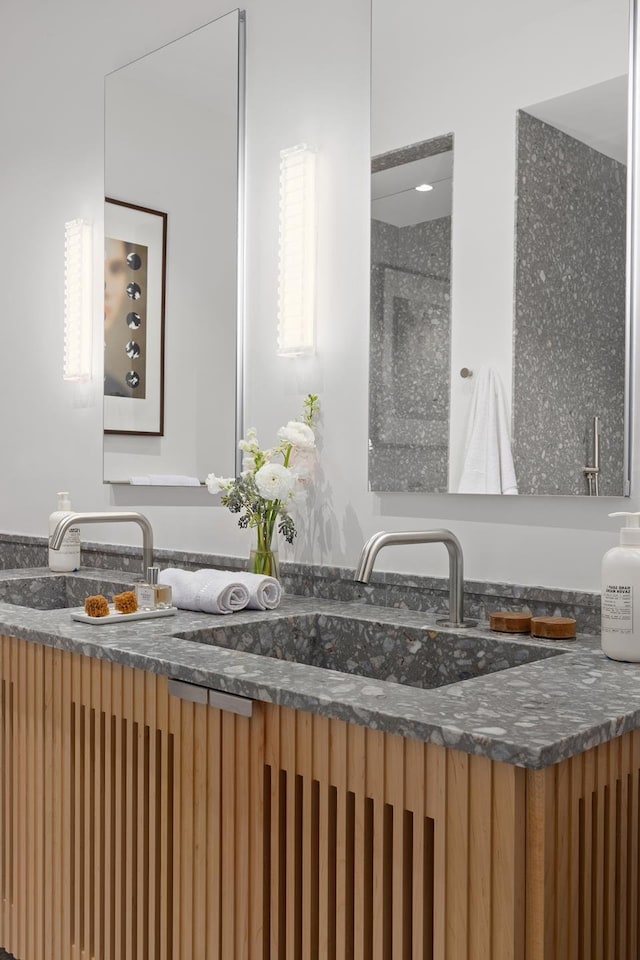 bathroom with a sink and double vanity