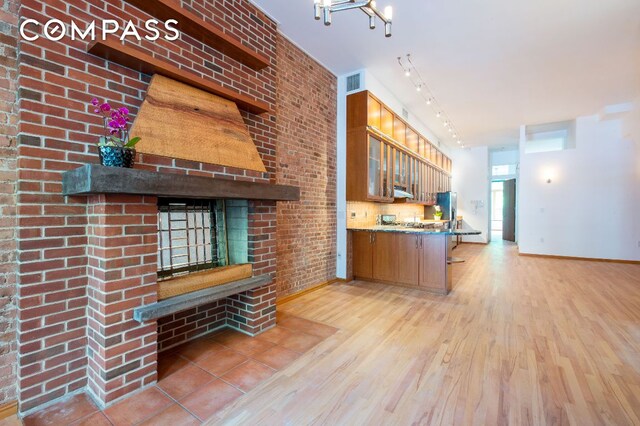 spare room with ceiling fan, plenty of natural light, a wall mounted AC, and light hardwood / wood-style flooring