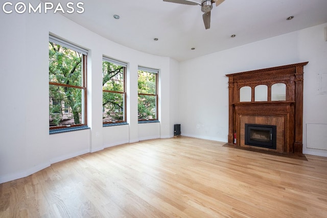 unfurnished living room with ceiling fan and light wood-type flooring